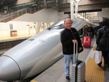 Dennis and the bullet train we rode from Beijing to Xi'an, China. Photo by Jill Miller