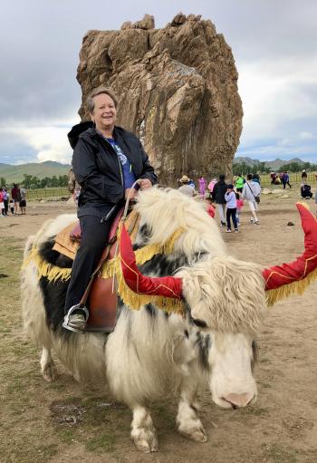 Leslie Geffen riding a yak around Taikhar Rock.