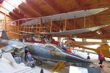 A replica of the Silver Dart hangs above a CF-104 Starfighter at the Atlantic Canada Aviation Museum.