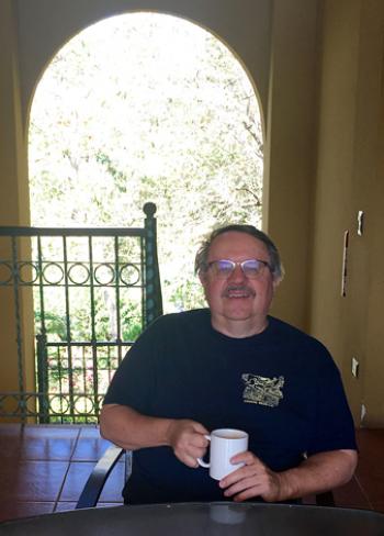 Glenn Schmidt enjoying Costa Rican coffee in an open stairwell of his rented condo. Photo by Cathy Pagel