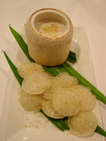The final presentation — rice cakes on pandan leaves, with the coconut sauce topping in a coconut.