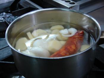 Cooking the onions, potatoes, garlic and chorizo.