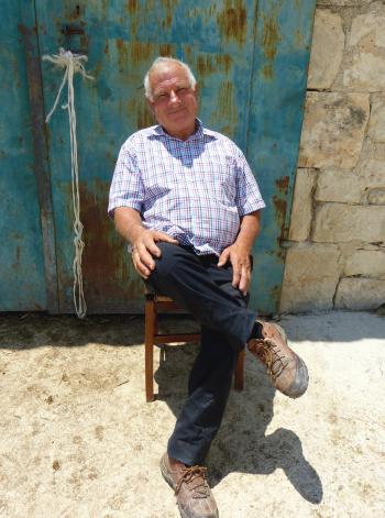 Ture Cacamo, a Sicilian dairy farmer, relaxing in front of his barn.