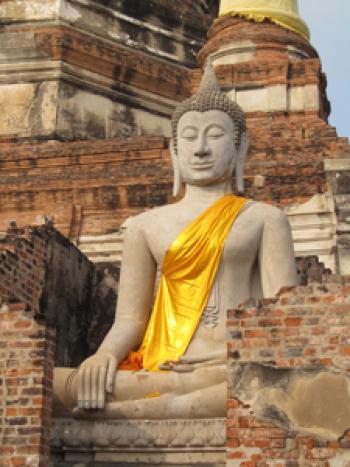 Statue of Buddha draped in orange cloth — Wat Yai Chai Mongkon, Ayutthaya, Thailand. Photo by Julie Skurdenis