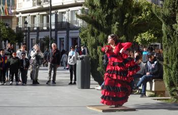 A flamenco dancer performs in a square in Seville.