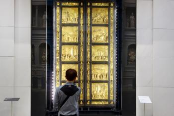 A visitor admires Lorenzo Ghiberti’s “Gates of Paradise” in Florence’s newly refurbished Duomo Museum. Photo by Rick Steves