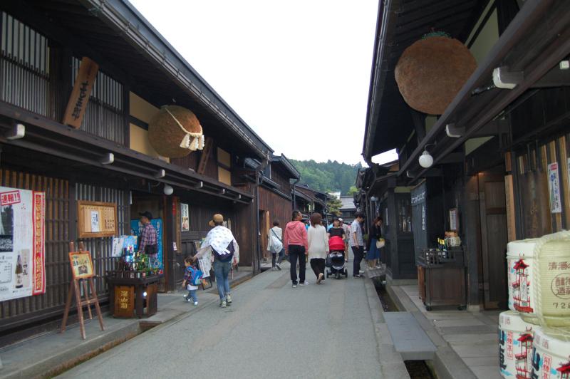 Sanmachi Street in Takayama — large balls of cedar boughs can be seen above the entrances to sake breweries. Green when tied, when the sake is first made, by the time the boughs are dried out, the sake should be ready to drink.