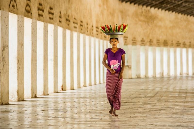 A watermelon seller walking in the causeway leading to Bagan’s Shwezigon Temple. Photo by Tom Cassen