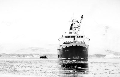 The Orlova towers over a small Zodiac.