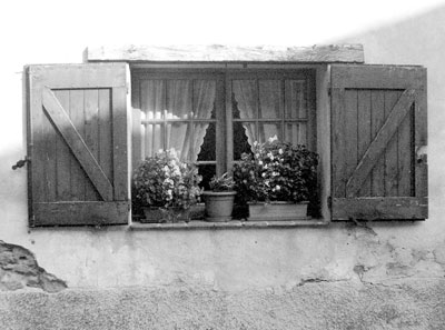 In Provençal villages, flowers, both wild and cultivated, are everywhere. This home, humble though it might be, was made memorable by these window boxes of begonias.