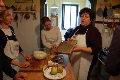 Judy Witts Francini explains herbs while Dana McMahan grates pecorino. Photo by Brian McMahan.