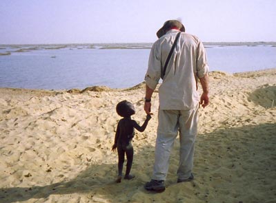 While waiting to cross the Niger River wetlands on the final leg of our trip to Timbuktu, a little guy latched on to me, as kids in Africa frequently do.
