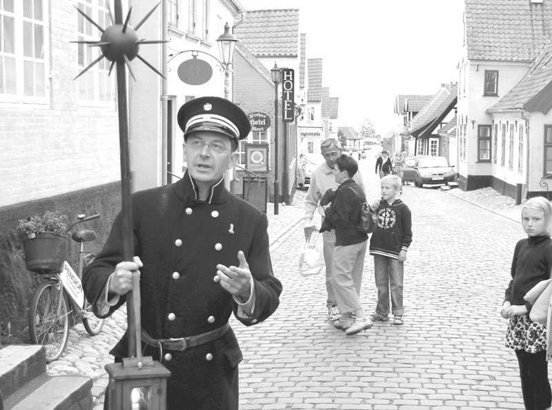 In the charming Danish island town of Eroskobing, the Night Watchman teaches and entertains nightly. Photo: Steves