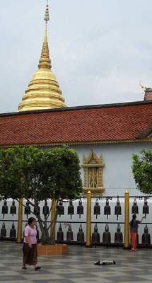 On the plaza at Wat Doi Suthep, bronze bells are sounded by monks and visitors.