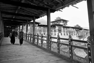 Monks crossing the world’s longest covered cantilevered bridge, Bhutan. Photo: Smillie