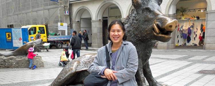 Niece, Dorothy, posing in front of a boar statue in Munich. 