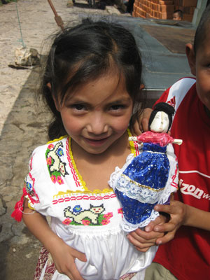 A young girl with her new corn-husk doll in the Mexican village of Sante Fe de la Laguna.