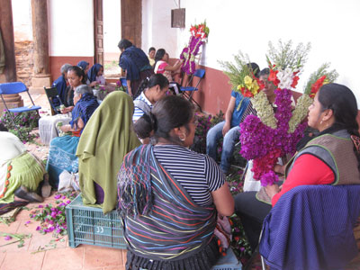 Preparing the flowers for the altars is a group effort.