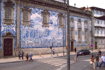 A large azulejo, the traditional blue-and-white tilework that can be found throughout Portugal, covers the exterior of a church in downtown Porto.