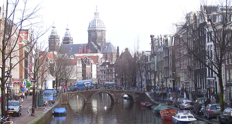 A view of a typical Amsterdam canal looking toward St. Nicholas Church.