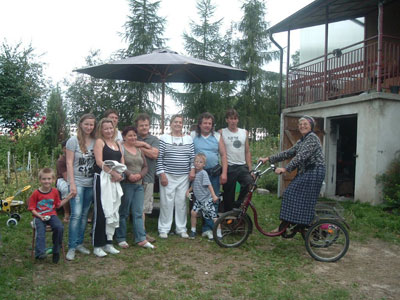 Mary Anne Christie (center) with Stasia (on bike) and her family at their home in Andrzejewie, Poland.