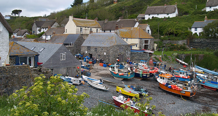 Colorful fishing boats pulled up in Cadgwith, a fishing village little changed from decades past.