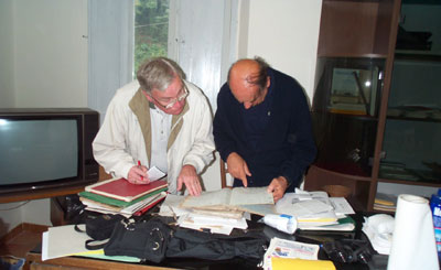 Bob Nulk (left) with pastor checking records at San Lorenzo Church in Pietrabuona, Pescia, Italy. Photo by Carol Ann Nulk