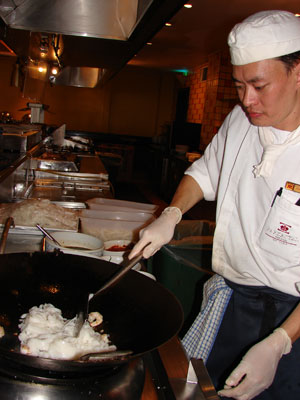 Chef Teng stirring in prawns and squid. Photos: Sandra Scott