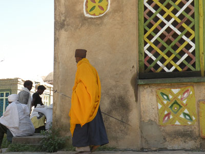 A cleric carrying a staff tipped with an Axum cross.