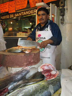Man filleting fish at the Mercado de San Juan. Photo: Dorothy Aksamit