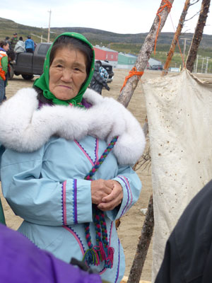 This woman demonstrated how to prepare a sealskin, stretching it between two poles — Kangiqsualujjuaq, or Georges River, Quebec. Photo: Jessell