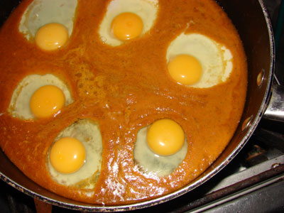 Eggs cooking in the sauce. Photos by 
