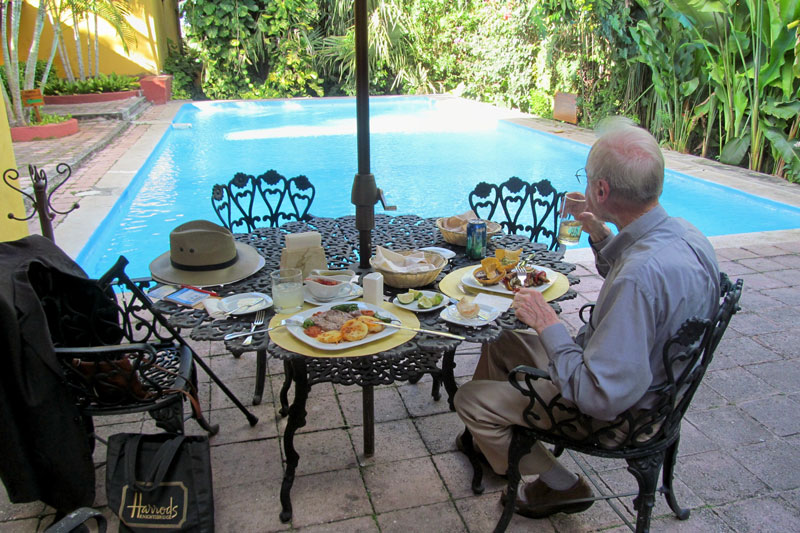 Paul Lalli dining beside the pool at Hacienda Misné, near Mérida in Yucatán, México. Photos by Julie Skurdenis