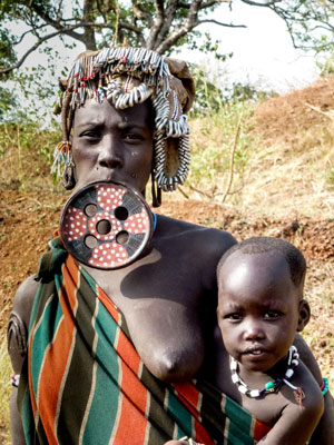 A Mursi tribeswoman and child. Lip plates are temporary and easily removed. Photo by Sandra Anderson