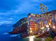The picture-perfect setting of the Cinque Terre villages (in this case, Riomaggiore) draws millions of tourists annually. Photo by Dominic Arizona Bonuccelli