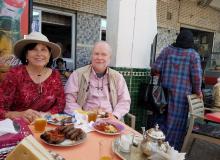 Paula Owens and husband, Stephen Addison, enjoying a kebab lunch outside a small café in Moulay Idriss, Morocco. Photo by guide Abdellah El Harras