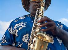 Musician playing the saxophone near the port of Nassau, New Providence Island, The Bahamas, Caribbean.