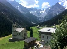 Driving through the mountains of northern Italy on a beautiful sunny day in August 2018, I came across this quaint mountain village with a glacier in the background. Photo by Liz Fischer