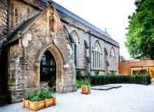 The exterior of The Garden Museum, which is housed in a deconsecrated London church, with the “floating” café in the distance. Photo by Andrew Burton, The Garden Museum