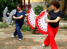 Two women performed morning exercises in the courtyard of Lou Lim Iok Garden.