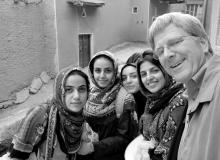 Rick Steves poses with teenage girls in Iran, a place that might give many Americans culture shock.