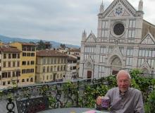 Paul Lalli at breakfast on the terrace of “Miravista” in the Palazzo Antellesi, with the church of Santa Croce visible in the background.