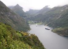 Geiranger village seen from Ørnesvingen (Eagle’s Bend) Lookout. The road to the lookout is full of hairpin curves like the one on the left. Photo: Prindle