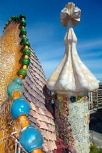 Detail of a curved-back dragon on the roof of Casa Battló, the exterior of which was designed by Antoni Gaudí — Barcelona, Spain. Photo: ©portokalis/123rf.com