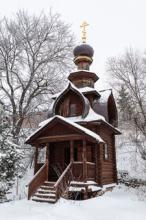 A small, snow-covered wooden chapel located near the sacred springs on the grounds of Savva-Storozhevsky Monastery in Sergiev Posad, Moscow. Photo: ©Viktor Sagaydashin/123rf.com