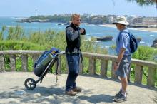 On a headland in Biarritz, France, in June 2015, Randy Keck (right) chatted with the Dutchman Gysbert Haaksman, who was on a 2,500-kilometer pilgrimage from the Netherlands to Santiago de Compostela, Spain, pulling a 30-pound backpack apparatus that had a single wheel. 