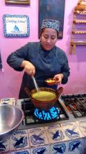 Chef/instructor Ruth Ruiz cooking in a traditional clay pot.