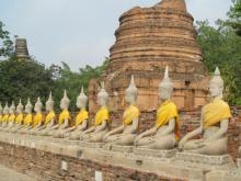 Buddha statues line all four sides of the temple enclosure at Wat Yai Chai Mongkol — Ayutthaya, Thailand. Photos by Julie Skurdenis