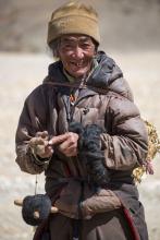 Tibetan man making a spool of wool from yak hair (in China). Photo ©piccaya/123rf.com