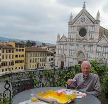 Paul Lalli at breakfast on the terrace of “Miravista” in the Palazzo Antellesi, with the church of Santa Croce visible in the background.